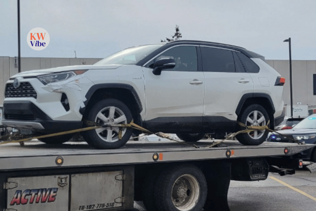 A white vehicle was photographed on the back of a tow truck