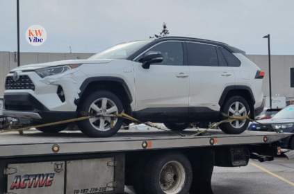 A white vehicle was photographed on the back of a tow truck